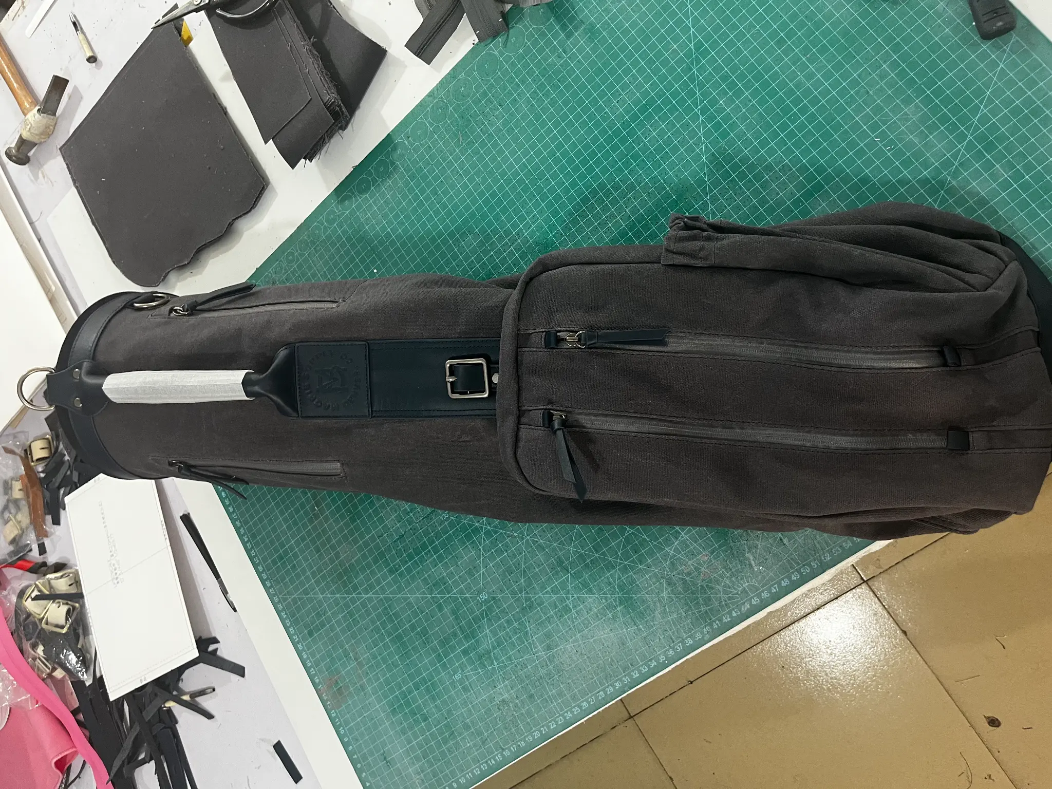 Black waxed canvas custom Sunday golf bag for Magpie Supply during final production inspection